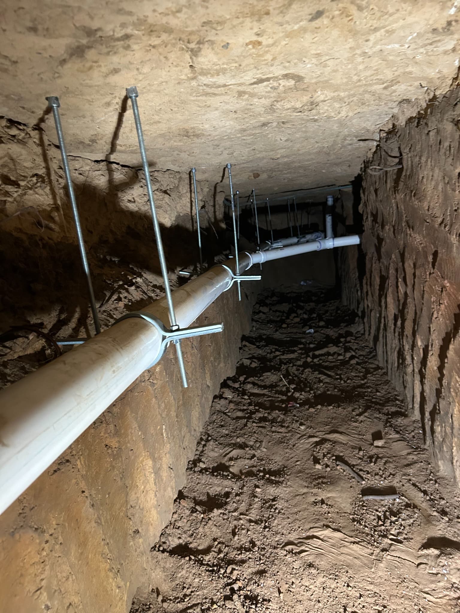 Drain and sewer piping installed below a home