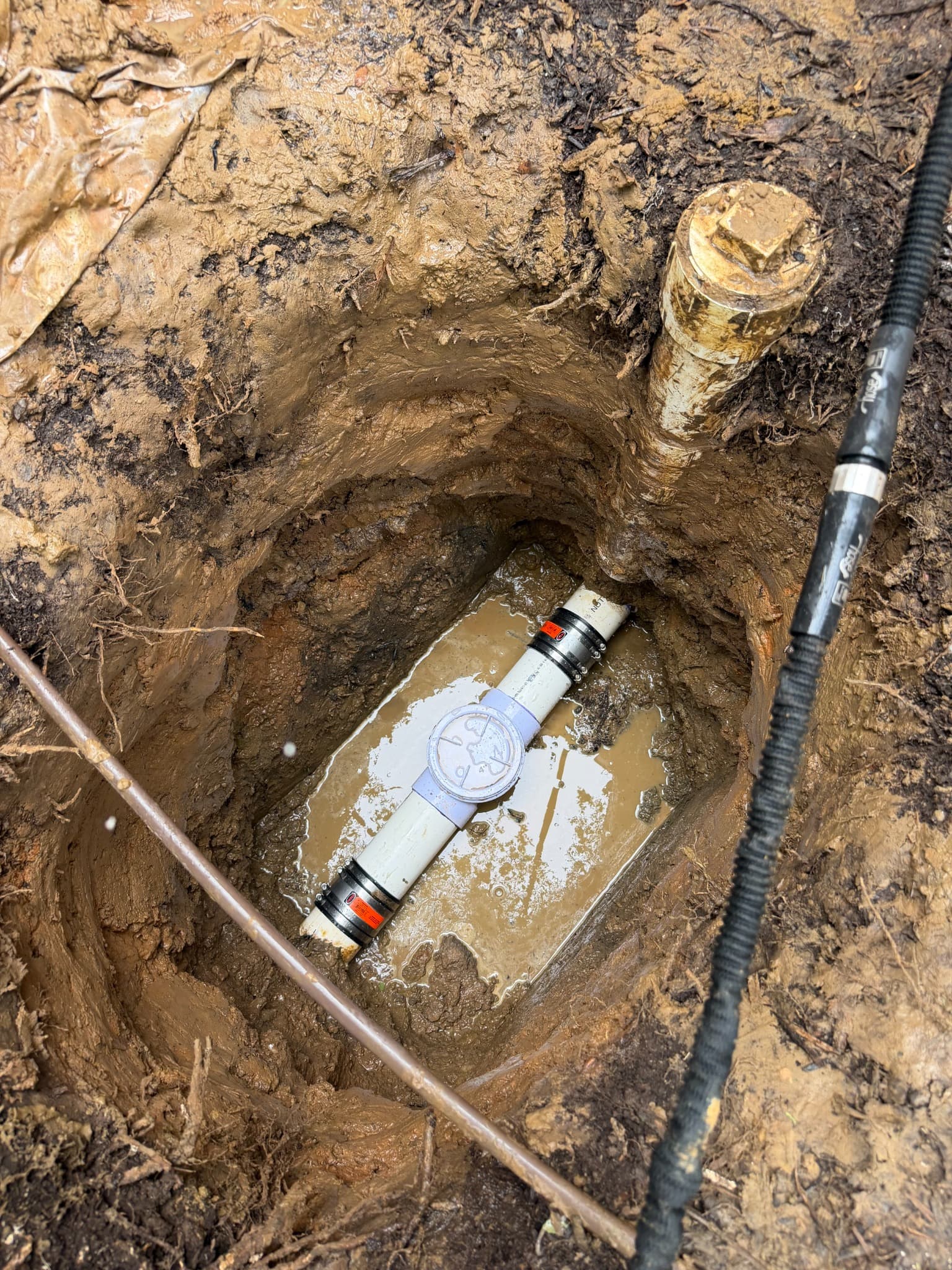 Underground drain line after repair with new PVC piping